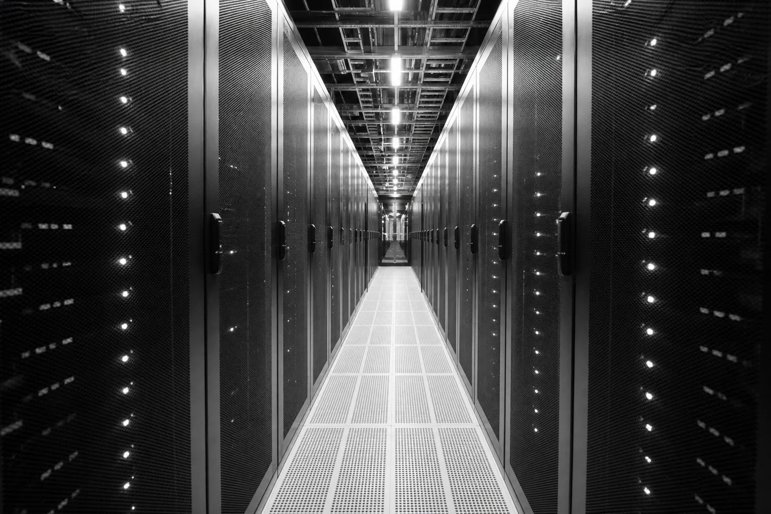 Long aisle between rows of server racks in a data center