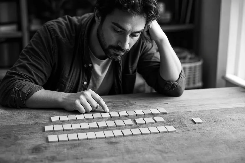 Rows of blank wooden letter tiles on a table