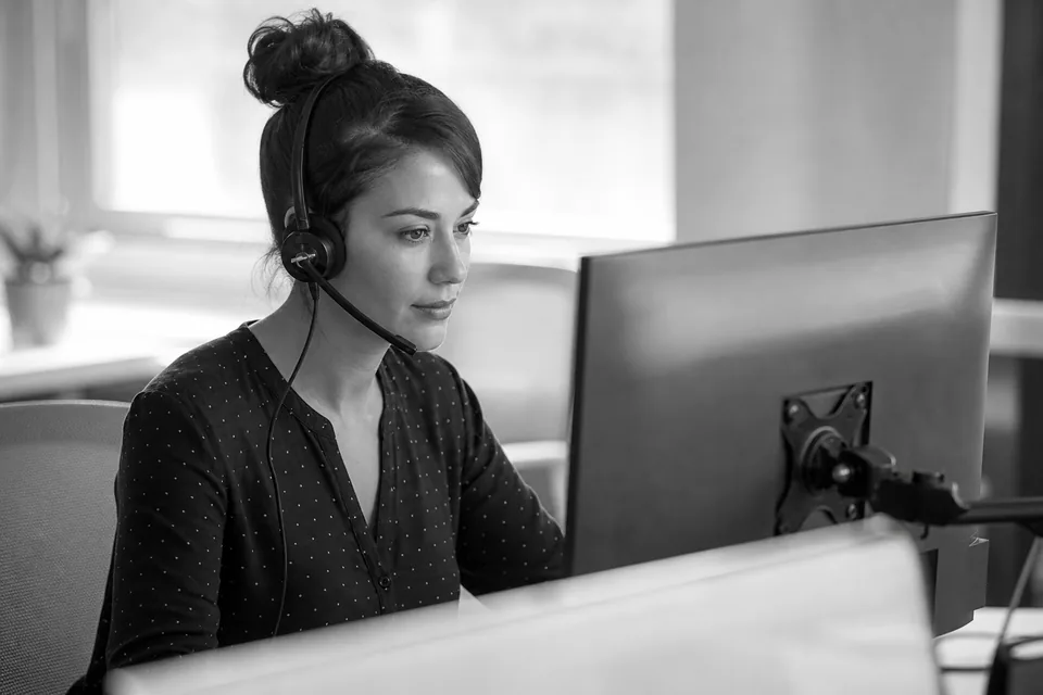 Support specialist with a headset working at a desk